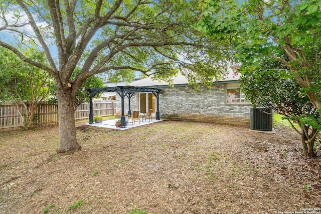 view of yard featuring a pergola, a patio, and central air condition unit