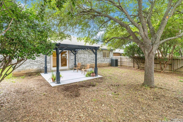 view of yard featuring central AC, a pergola, and a patio