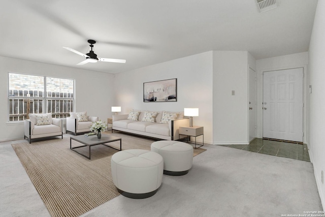 carpeted living room with ceiling fan