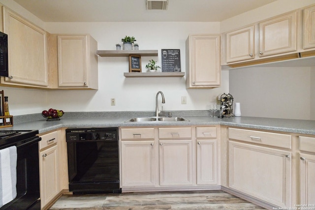 kitchen featuring light brown cabinetry, sink, light hardwood / wood-style flooring, and black appliances