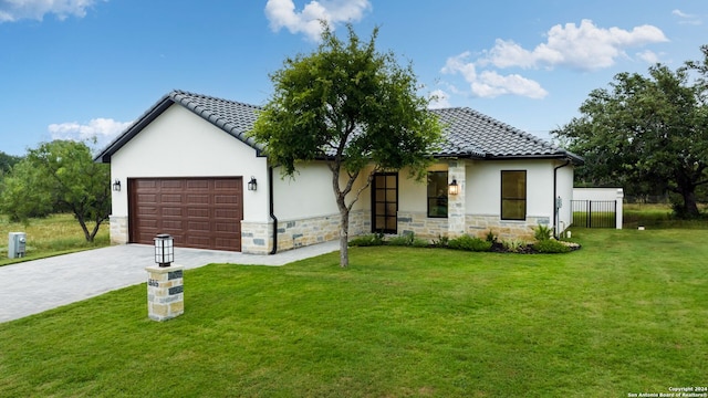 view of front of property with a garage and a front lawn