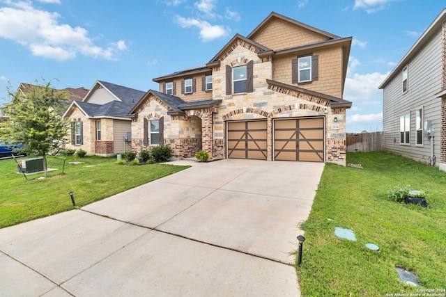 craftsman inspired home featuring a garage and a front lawn