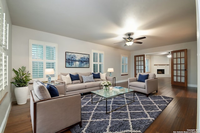 living room featuring dark hardwood / wood-style floors and ceiling fan