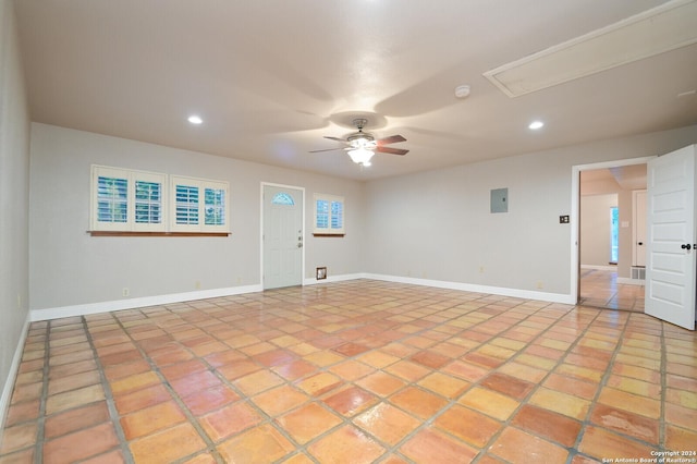 unfurnished room featuring ceiling fan and electric panel