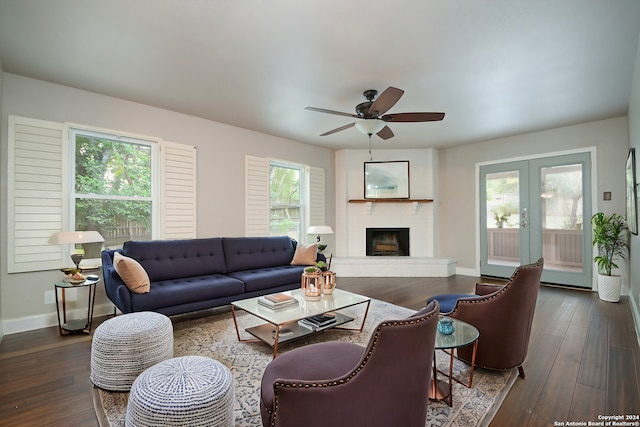 living room featuring dark wood-type flooring, french doors, and a healthy amount of sunlight