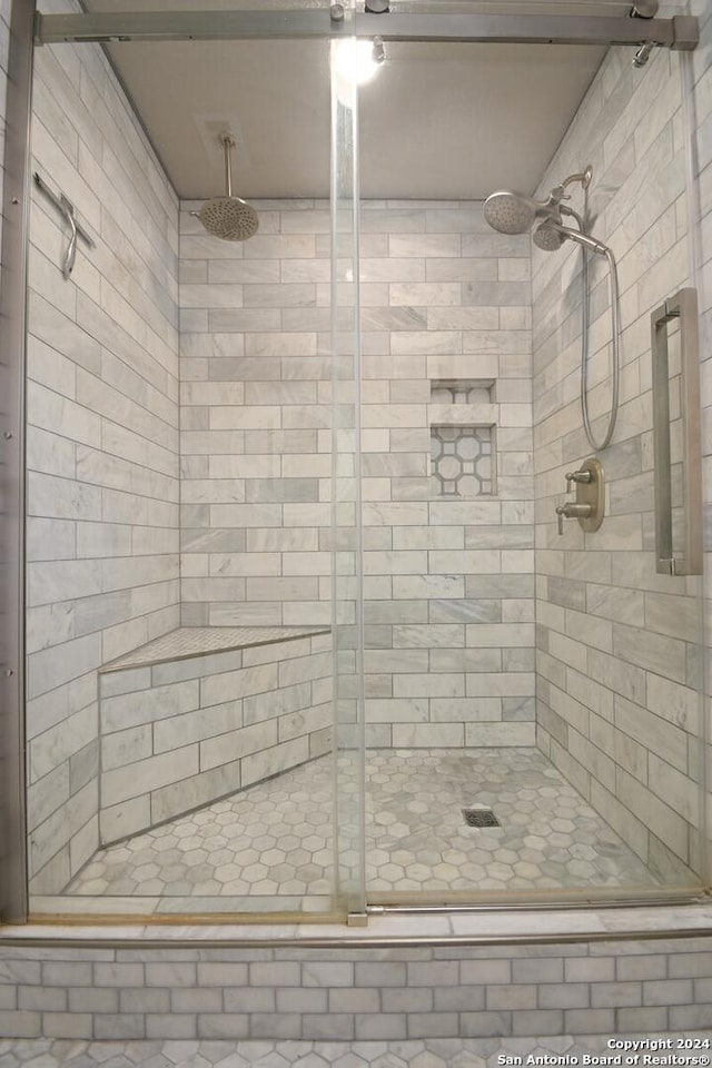 bathroom featuring a shower with shower door