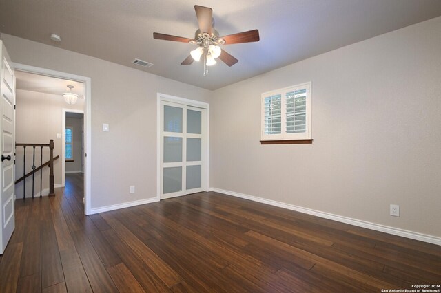 unfurnished room with dark hardwood / wood-style floors and ceiling fan