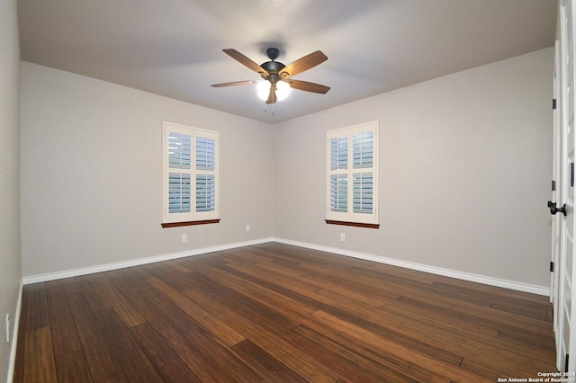 spare room featuring dark hardwood / wood-style floors and ceiling fan