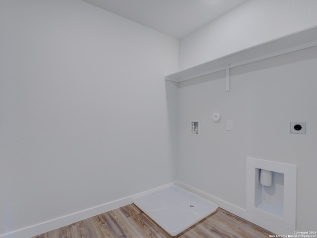 washroom with washer hookup, gas dryer hookup, electric dryer hookup, and light wood-type flooring