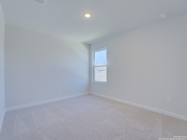 unfurnished room with light carpet