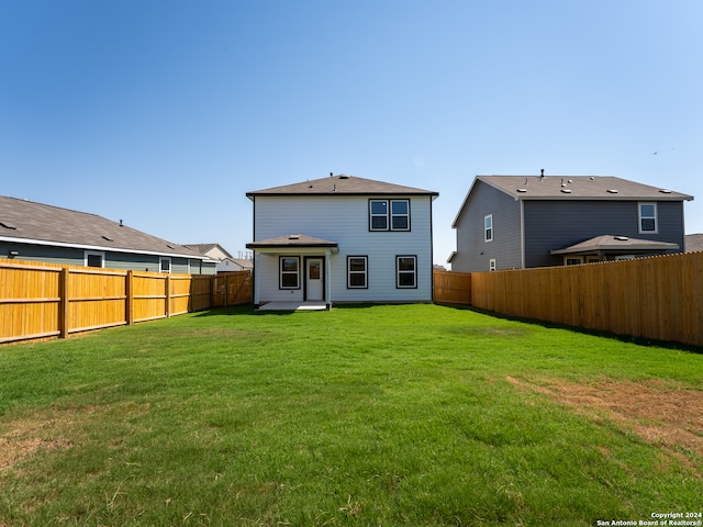 back of house with a yard