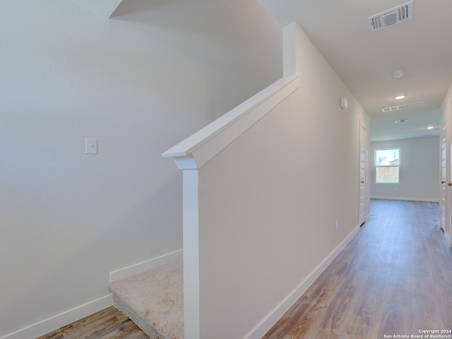 corridor with light hardwood / wood-style flooring