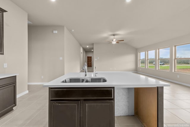 kitchen with sink, an island with sink, ceiling fan, and light tile patterned floors