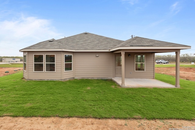 back of house featuring a patio area and a lawn