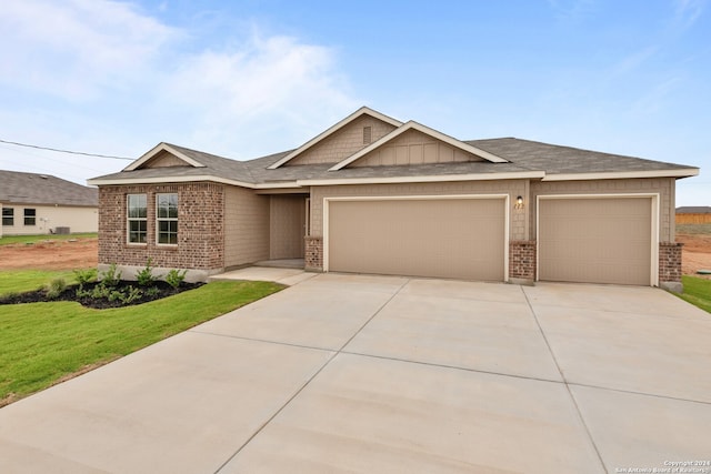 view of front of home with a garage and a front lawn