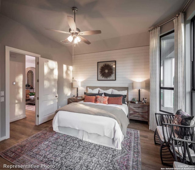 bedroom featuring dark wood-type flooring, vaulted ceiling, and ceiling fan