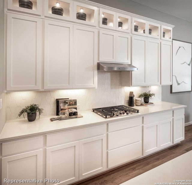 kitchen with white cabinetry, dark wood-type flooring, and stainless steel gas stovetop