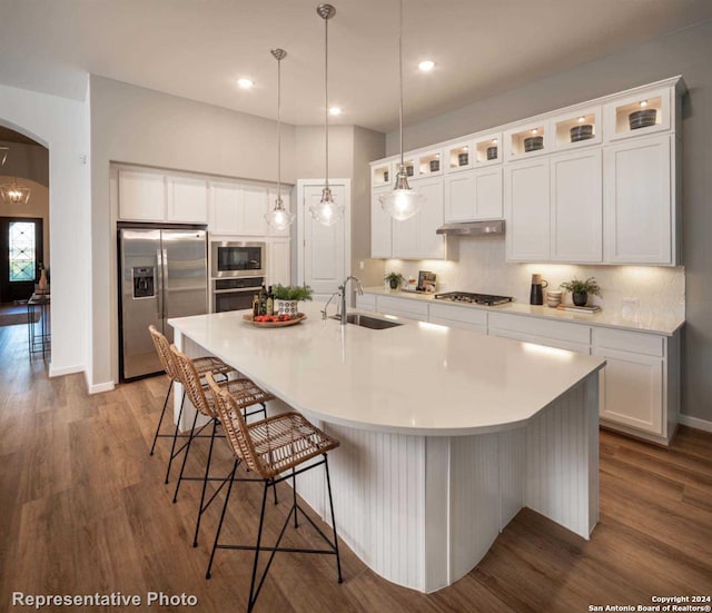 kitchen with appliances with stainless steel finishes, sink, and white cabinets