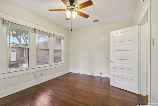 unfurnished room featuring dark hardwood / wood-style floors and ceiling fan