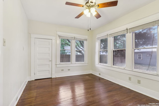 spare room featuring ceiling fan and dark hardwood / wood-style flooring