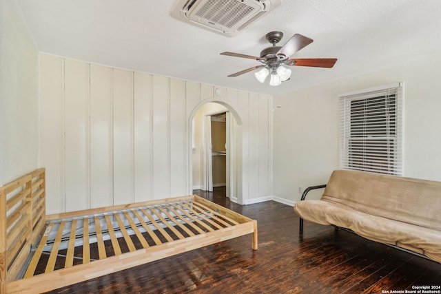 living area with ceiling fan and dark hardwood / wood-style flooring