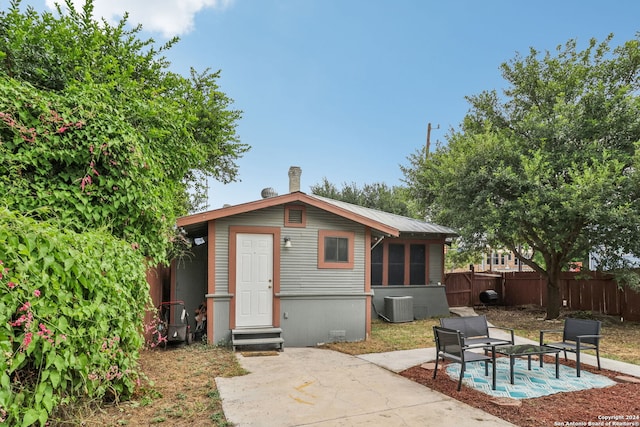 exterior space with a patio area, a sunroom, and central air condition unit