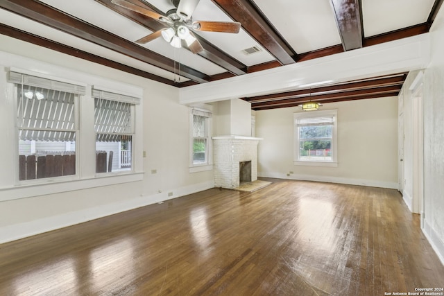 unfurnished living room with ceiling fan, dark wood-type flooring, a fireplace, and beam ceiling