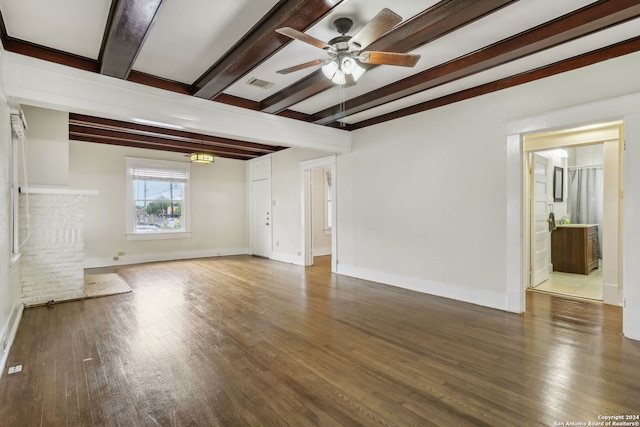 unfurnished living room featuring ceiling fan, wood-type flooring, and beam ceiling