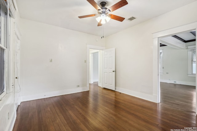 empty room featuring ceiling fan and dark hardwood / wood-style flooring