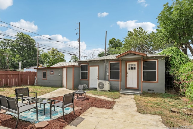 exterior space with ac unit and a patio area