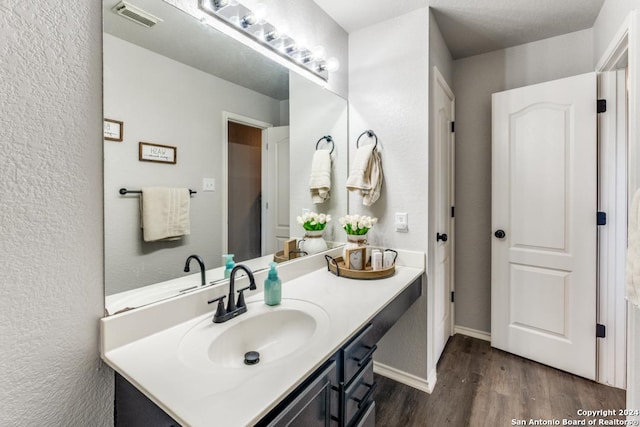 bathroom with vanity and hardwood / wood-style floors