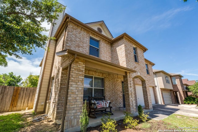 view of front of property with a porch and a garage