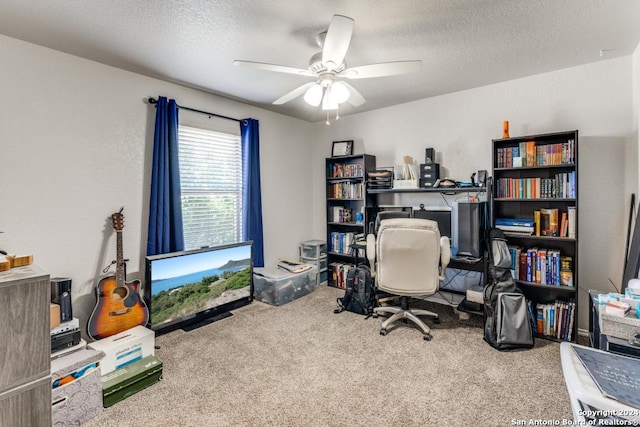 office area with ceiling fan, carpet flooring, and a textured ceiling