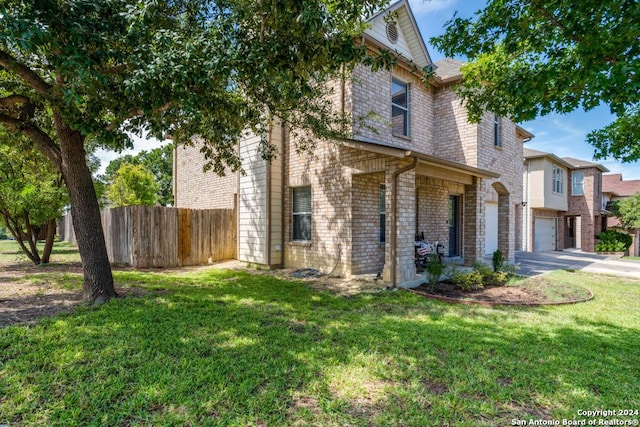 view of front of property featuring a garage and a front lawn