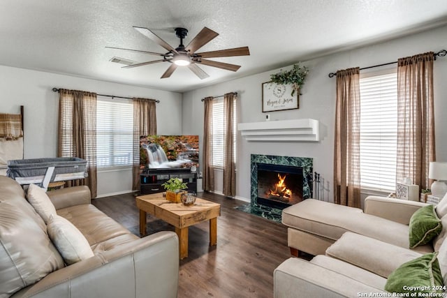 living room featuring dark hardwood / wood-style flooring, a healthy amount of sunlight, and a textured ceiling