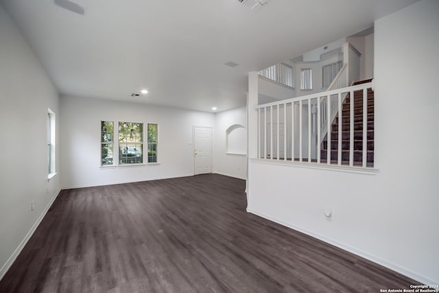 unfurnished living room featuring dark hardwood / wood-style flooring