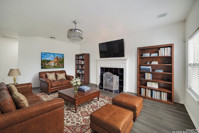 living room featuring a fireplace and dark hardwood / wood-style floors