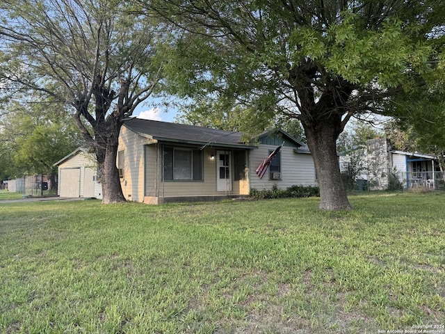 single story home featuring a garage and a front yard