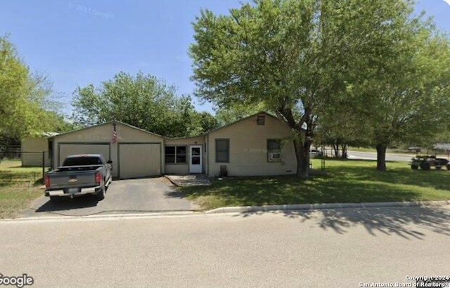 ranch-style home featuring a garage and a front yard