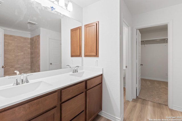 bathroom with wood-type flooring, toilet, and vanity