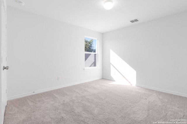 unfurnished room with light carpet