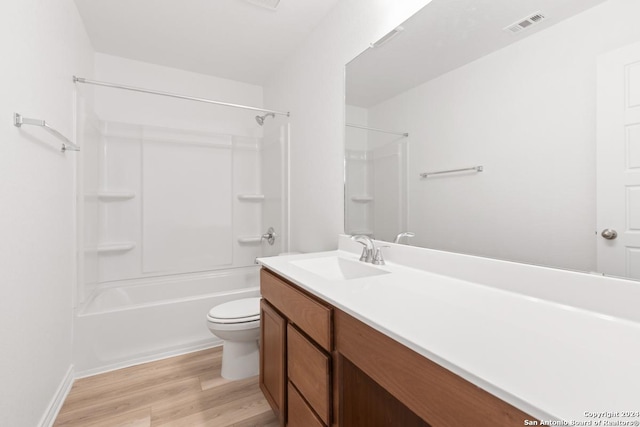 full bathroom with vanity, hardwood / wood-style flooring, shower / bath combination, and toilet