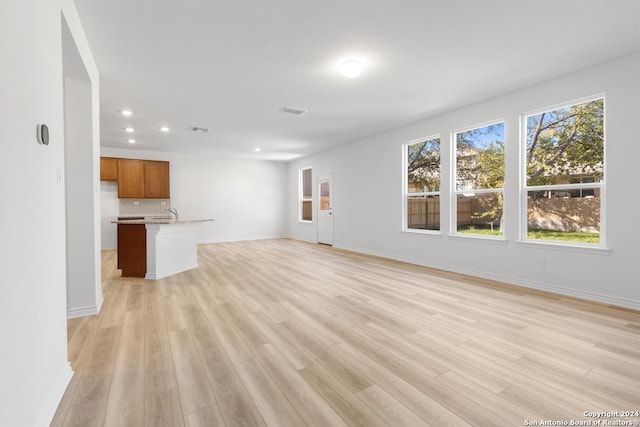 unfurnished living room with light wood-type flooring