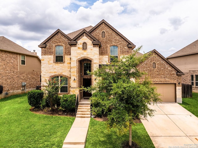 view of front of property with a garage and a front yard