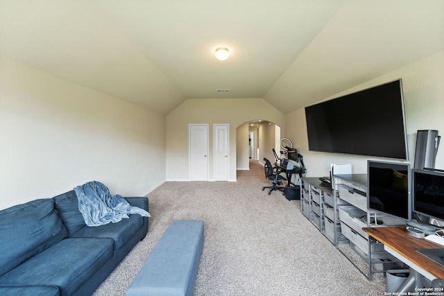 carpeted home office featuring lofted ceiling