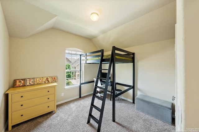 carpeted bedroom featuring lofted ceiling