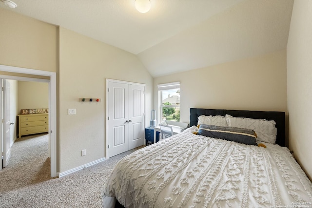 bedroom featuring lofted ceiling, light colored carpet, and a closet