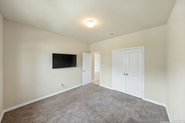 unfurnished bedroom featuring a closet and carpet