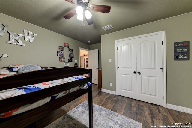 bedroom featuring dark hardwood / wood-style flooring, a closet, and ceiling fan