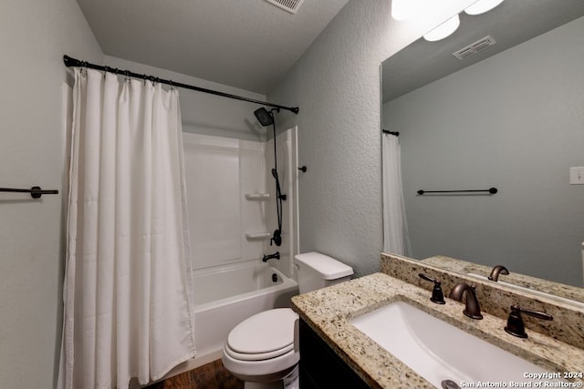 full bathroom with shower / bath combination with curtain, vanity, and toilet